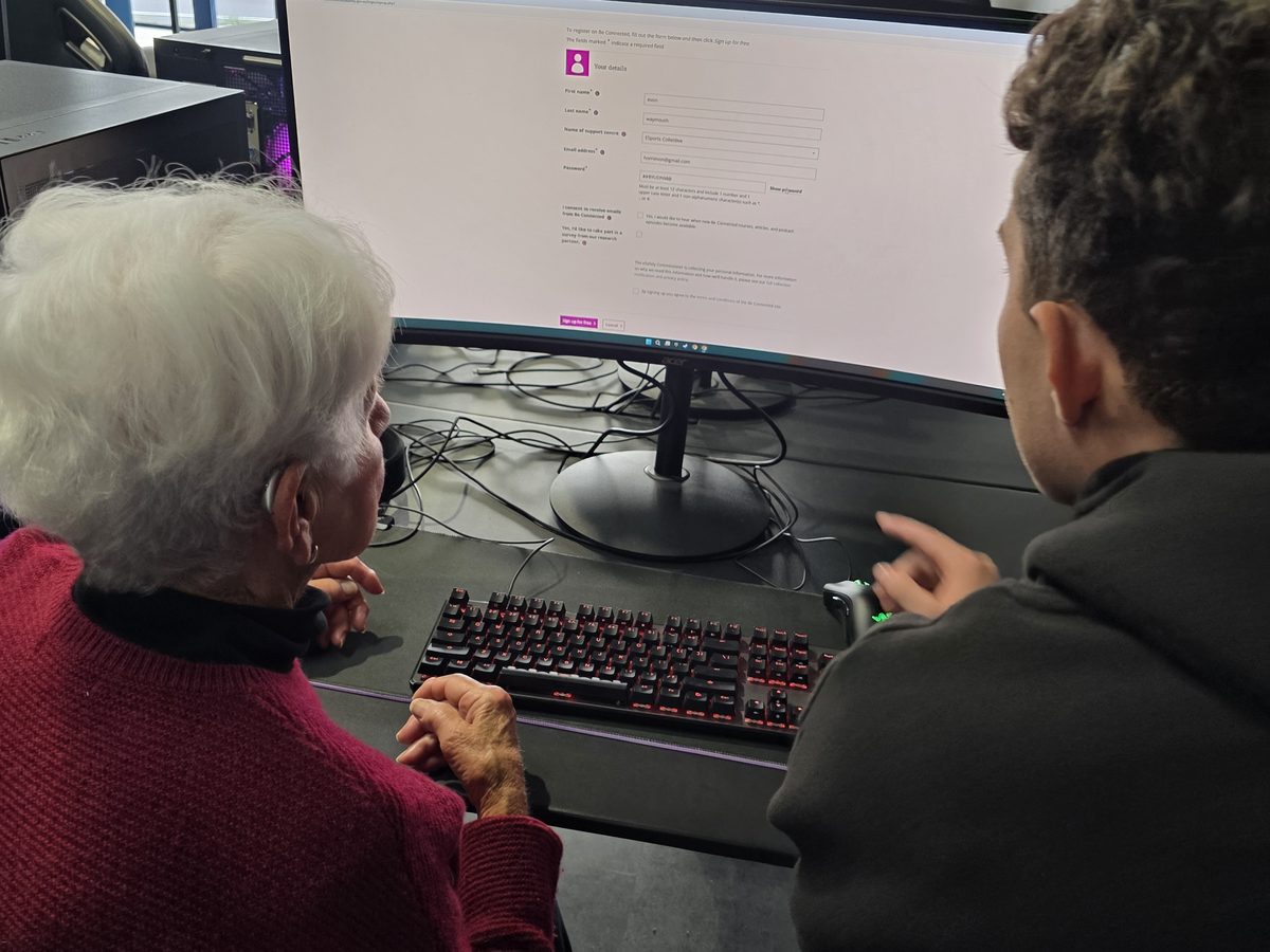 A learner getting patient help with a device